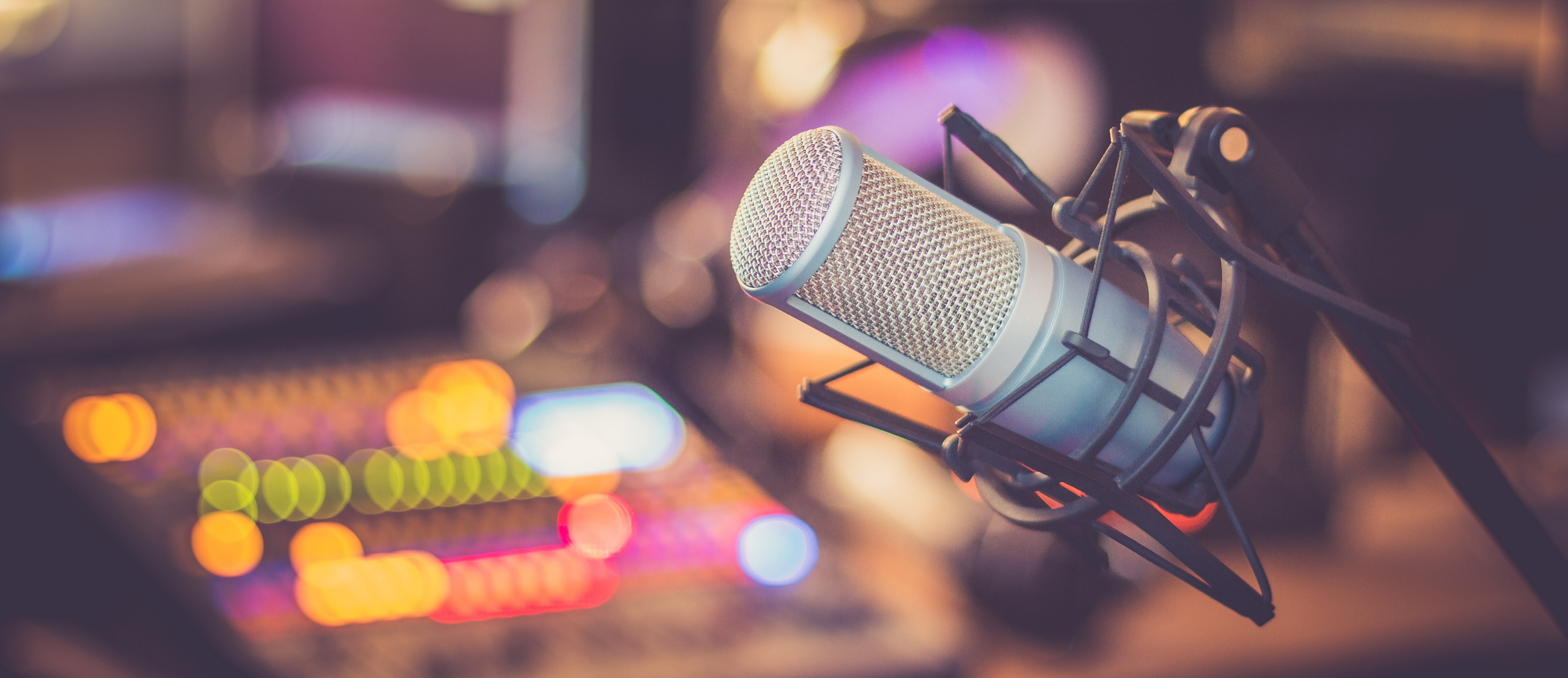 A studio microphone suspended above a recording desk